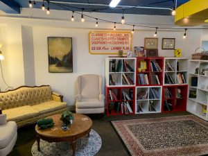 inside of Birdhouse Books with shelves, tables and places to sit