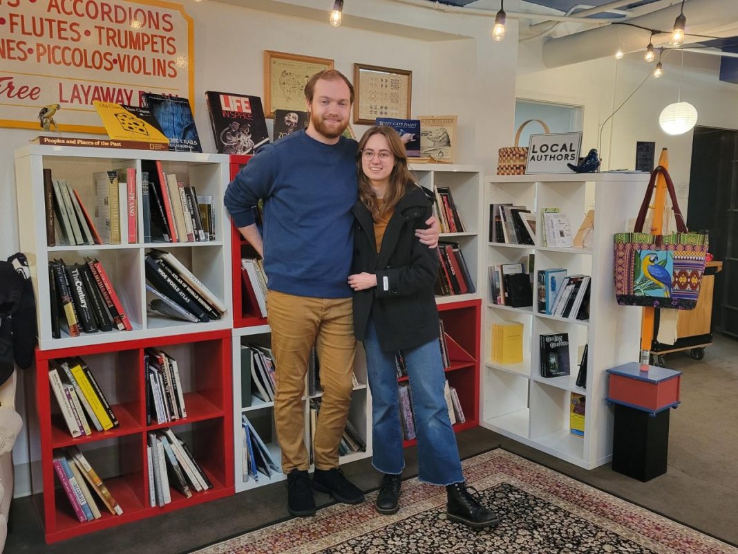 Lucas Gubala and Sarah Summerhill standing in front of books shelves at Birdhouse Books