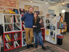 Lucas Gubala and Sarah Summerhill standing in front of books shelves at Birdhouse Books