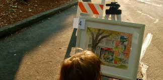 little girl looking at a piece of art in downtown Camas