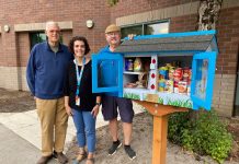 Bob Chapman, Shanna Baird, and Duane Sich standing by a Little Food Pantry food bank in Vancouver
