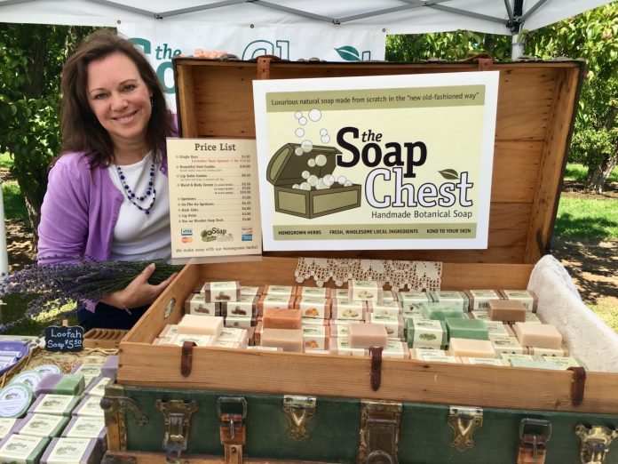 Gail Horn, owner of The Soap Chest in Camas, next to a display of her soaps