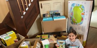 Lily Strickland city with boxes of donated toys