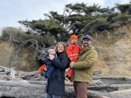 Jane and Lucas Shuler and their two kids standing by the Tree of LIfe in Kalaloch Campground
