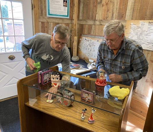 Ivar Godtlibsen and Richard Johnson cleaning a display at the Two Rivers Heritage Museum
