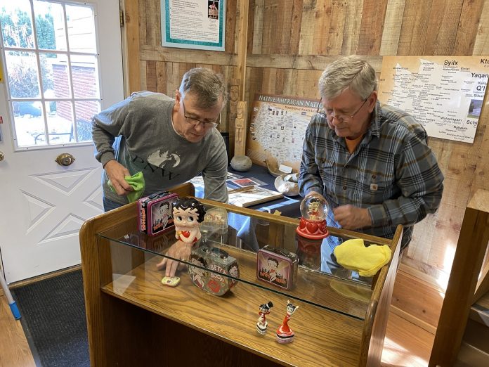 Ivar Godtlibsen and Richard Johnson cleaning a display at the Two Rivers Heritage Museum