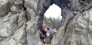 Father and son climbing on rocks at Ruby Beach