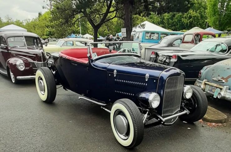classic convertible car with white walls in a parking lot