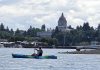 Kayaker on Budd Bay with the Olympia Capitol building in the background
