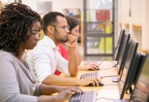 students at computers on a long desk